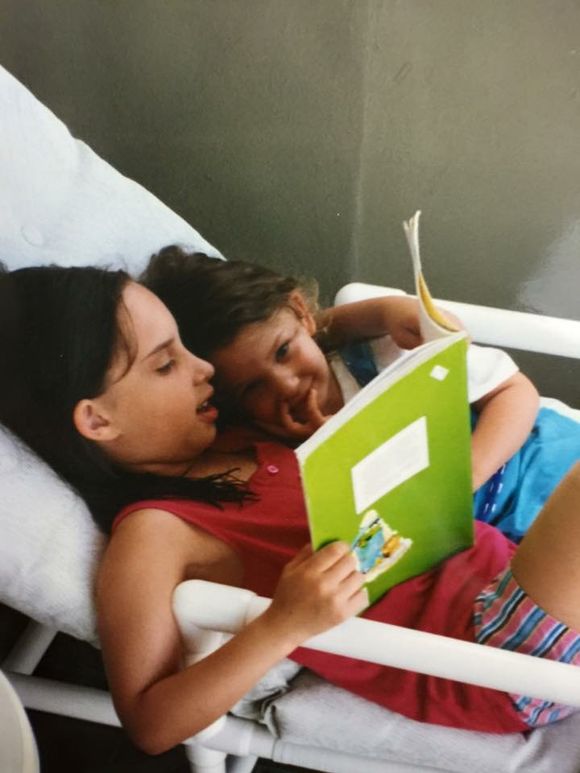 Samara reading to her younger sister